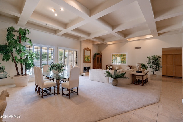 dining space featuring beamed ceiling, light tile patterned flooring, and coffered ceiling