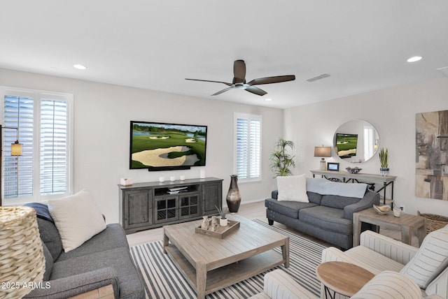 living room featuring ceiling fan and wood-type flooring