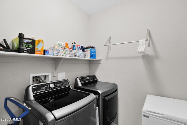 laundry area with independent washer and dryer