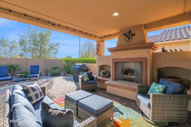 view of patio featuring grilling area and an outdoor living space with a fireplace