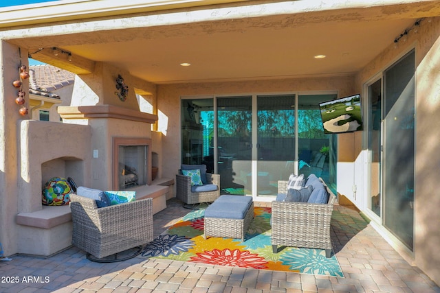 view of patio / terrace featuring exterior fireplace