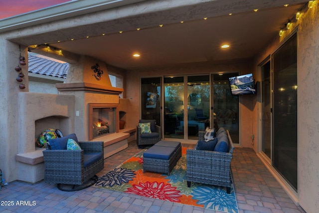 view of patio / terrace featuring an outdoor living space with a fireplace