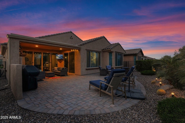 rear view of property with a patio area and an outdoor living space