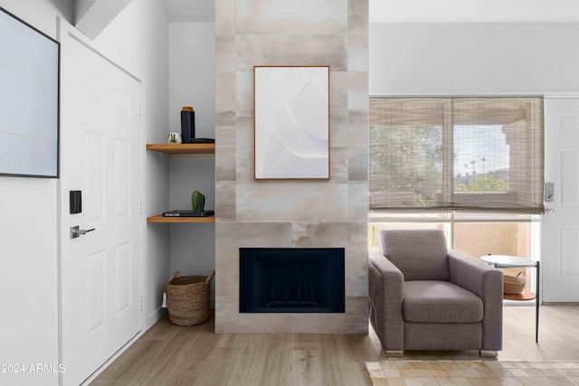 sitting room featuring a fireplace and light wood-type flooring