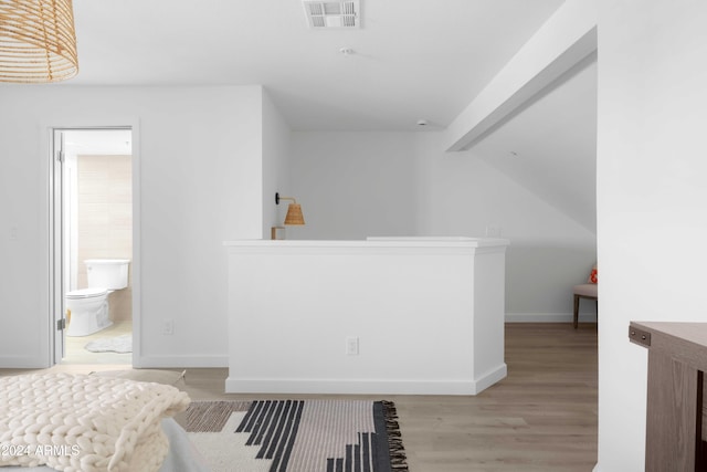 bathroom with hardwood / wood-style floors and toilet