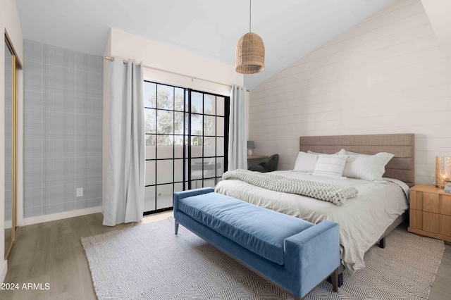 bedroom featuring hardwood / wood-style flooring and vaulted ceiling