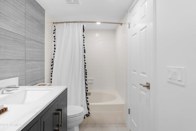 full bathroom with tile patterned floors, vanity, shower / tub combo with curtain, tile walls, and toilet