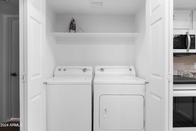 laundry area with washing machine and clothes dryer