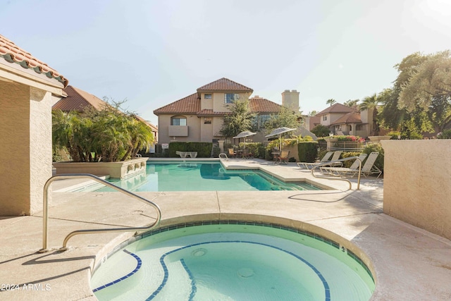 view of pool featuring a patio area and a hot tub