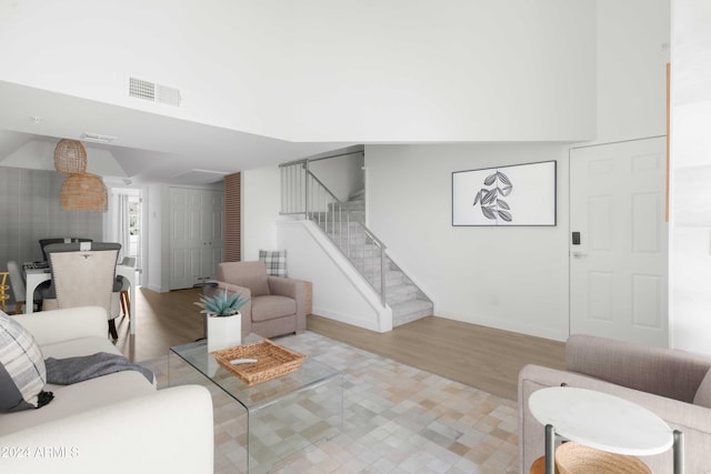 living room with light wood-type flooring and lofted ceiling