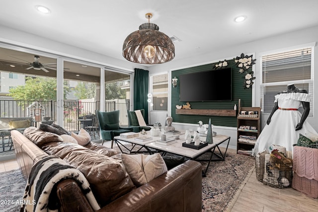 living room with light hardwood / wood-style flooring and ceiling fan