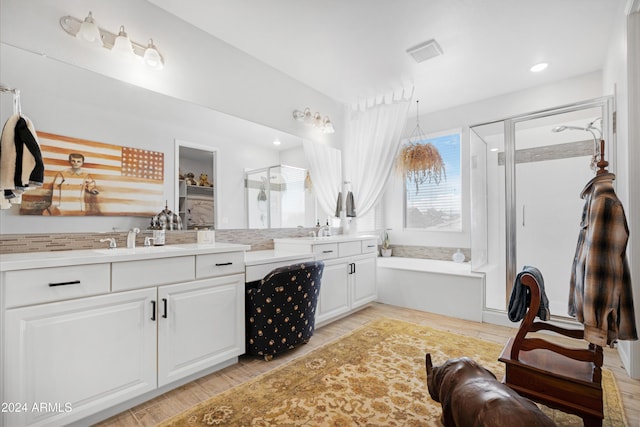 bathroom featuring vanity, separate shower and tub, and wood-type flooring