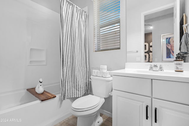 full bathroom featuring hardwood / wood-style floors, vanity, toilet, and shower / bathtub combination with curtain