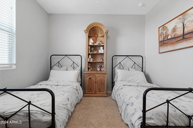 bedroom with light colored carpet