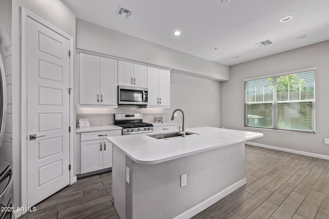 17118 N 50th Way, Scottsdale, AZ 85254 - kitchen featuring appliances with stainless steel finishes, wood finished floors, white cabinets, light countertops, and decorative backsplash