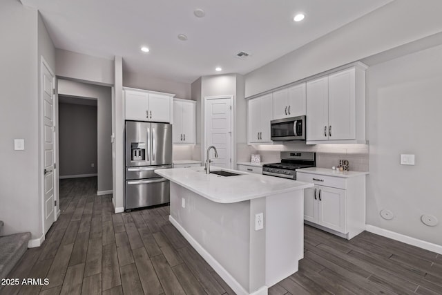 17118 N 50th Way, Scottsdale, AZ 85254 - kitchen featuring stainless steel appliances, dark wood finished floors, light countertops, white cabinetry, and a center island with sink