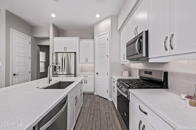 17118 N 50th Way, Scottsdale, AZ 85254 - kitchen featuring stainless steel appliances, white cabinets, dark wood finished floors, light stone counters, and recessed lighting