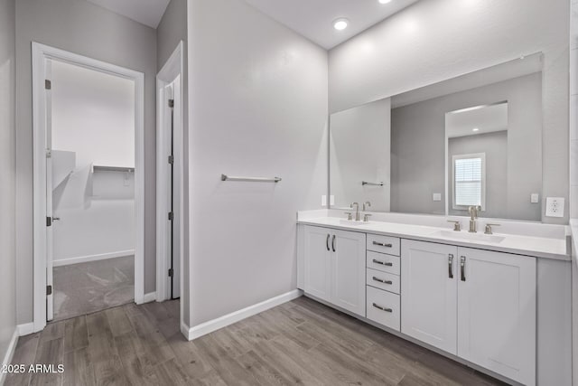 17118 N 50th Way, Scottsdale, AZ 85254 - bathroom featuring double vanity, wood finished floors, a walk in closet, and recessed lighting
