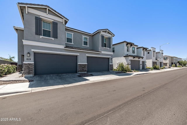 17118 N 50th Way, Scottsdale, AZ 85254 - townhome / multi-family property featuring stucco siding, stone siding, a garage, and a residential view