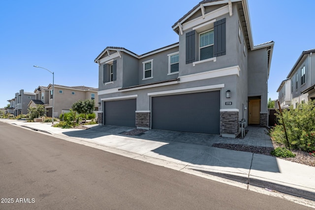 17118 N 50th Way, Scottsdale, AZ 85254 - view of front of home with stucco siding, stone siding, an attached garage, and a residential view