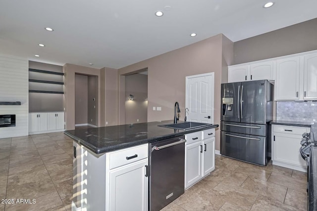 kitchen featuring white cabinetry, refrigerator with ice dispenser, decorative backsplash, and sink