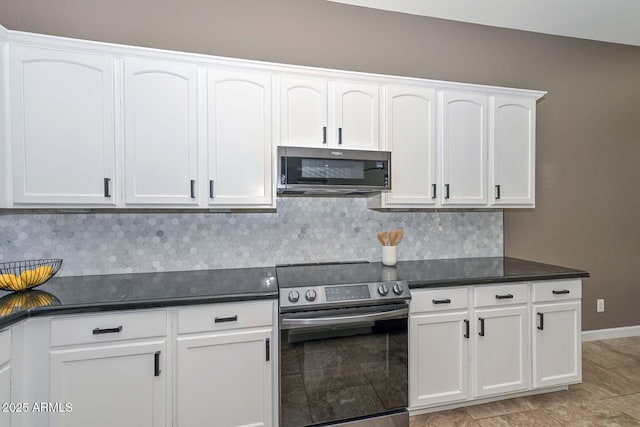 kitchen with stainless steel appliances, white cabinetry, and backsplash