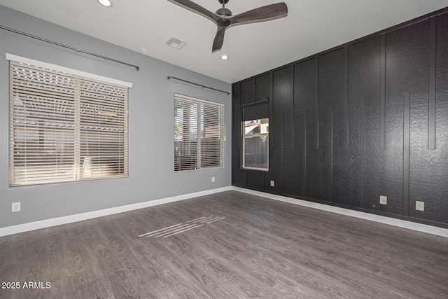 empty room featuring dark hardwood / wood-style floors and ceiling fan