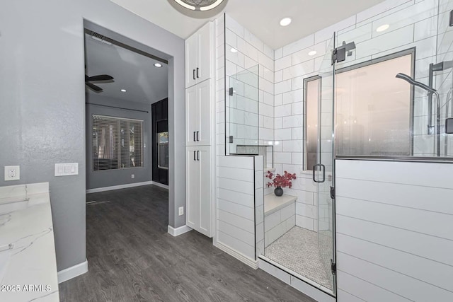 bathroom featuring a shower with shower door and hardwood / wood-style floors