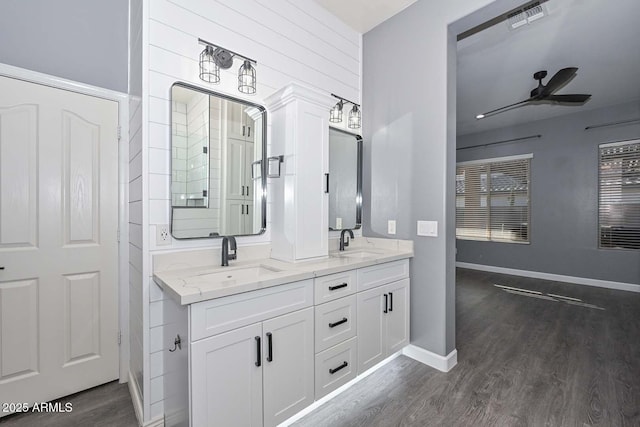 bathroom with hardwood / wood-style flooring, vanity, and ceiling fan