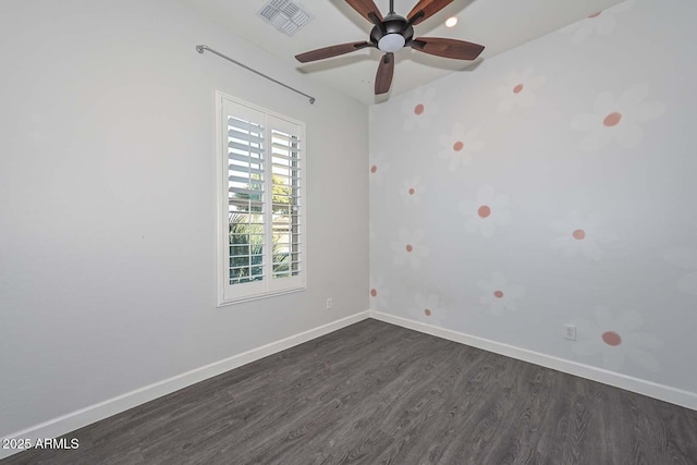 spare room featuring ceiling fan and dark hardwood / wood-style flooring