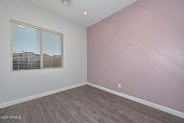 spare room featuring dark hardwood / wood-style floors