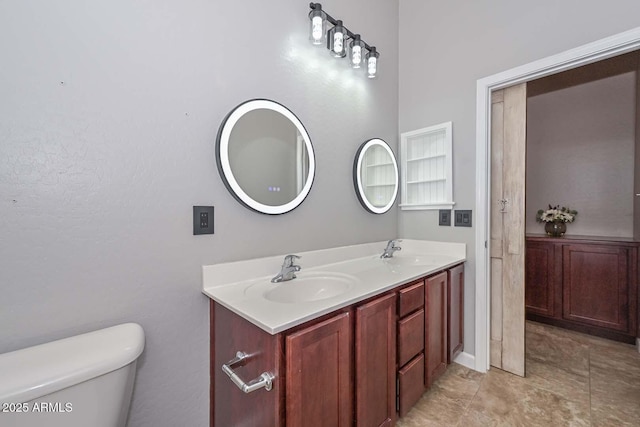 bathroom featuring vanity and toilet