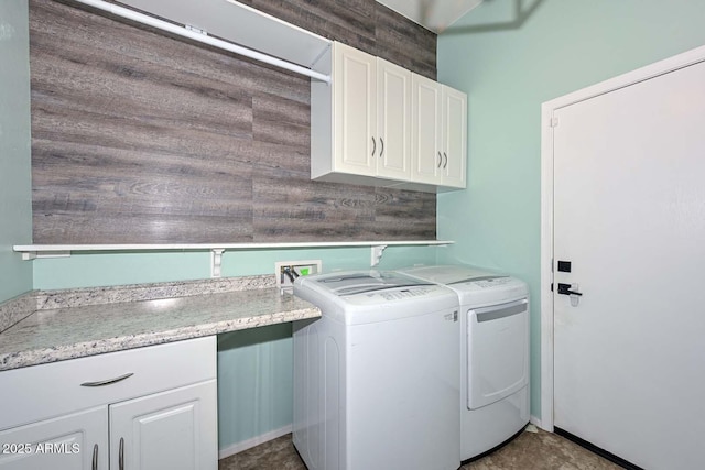 laundry area with cabinets and washing machine and dryer