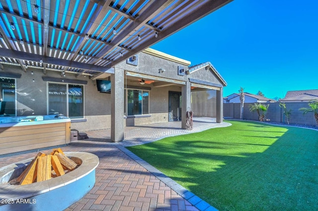 rear view of property with a yard, a pergola, and a patio area