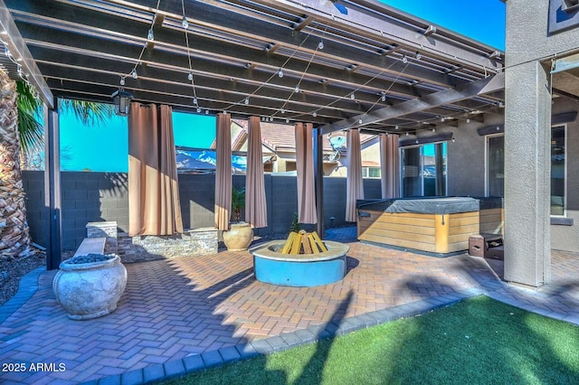 view of patio / terrace with an outdoor fire pit, a hot tub, and a pergola