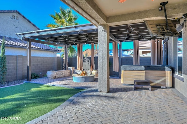 view of patio / terrace with a hot tub and ceiling fan