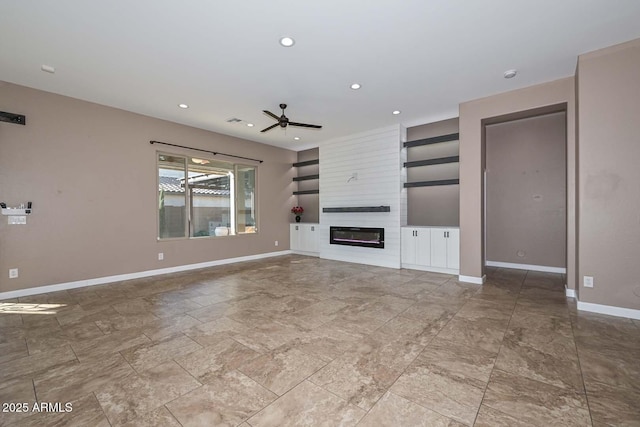 unfurnished living room featuring ceiling fan and a fireplace