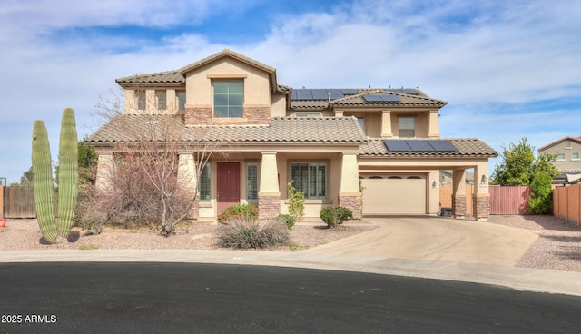 mediterranean / spanish-style house featuring stone siding, fence, driveway, and stucco siding