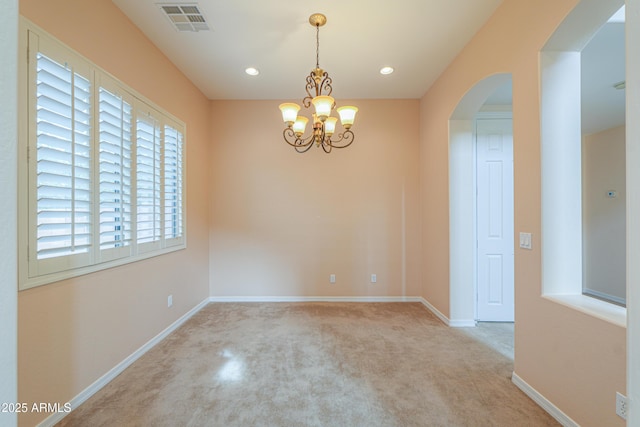 spare room featuring arched walkways, recessed lighting, visible vents, baseboards, and an inviting chandelier