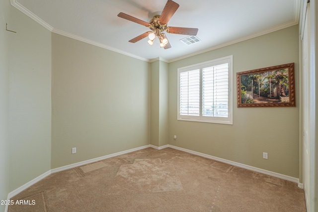 spare room featuring baseboards, light colored carpet, visible vents, and crown molding