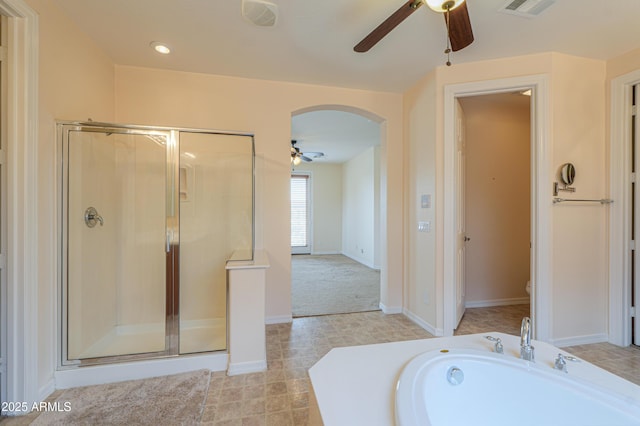 bathroom with a stall shower, visible vents, toilet, ceiling fan, and a bath