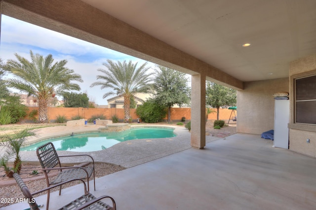 view of swimming pool with a fenced backyard, a fenced in pool, and a patio