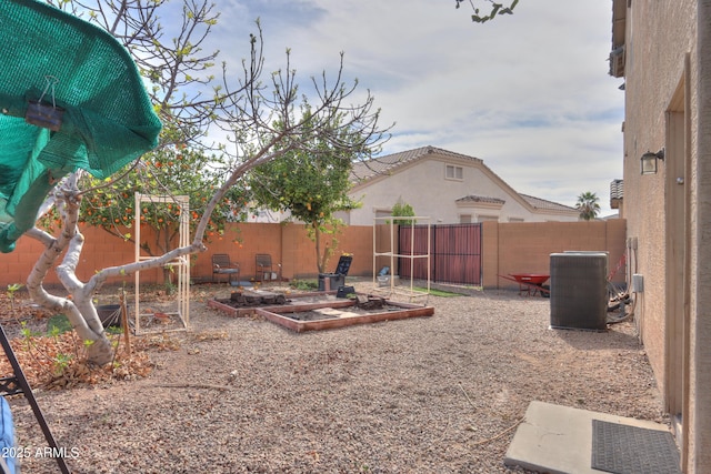 view of yard featuring a fenced backyard, cooling unit, and a garden