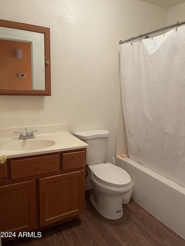 full bathroom featuring wood-type flooring, vanity, and toilet