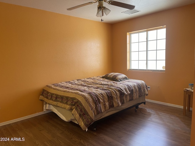 bedroom featuring ceiling fan and dark hardwood / wood-style floors