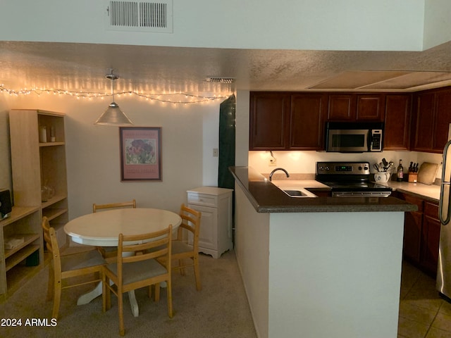 kitchen with stainless steel appliances, light tile patterned floors, and sink