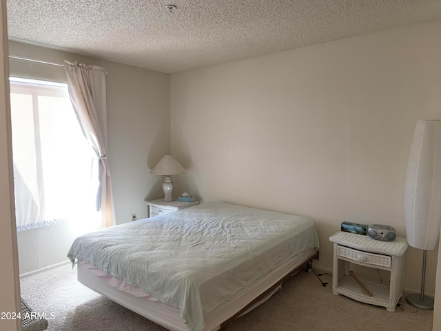 carpeted bedroom with a textured ceiling