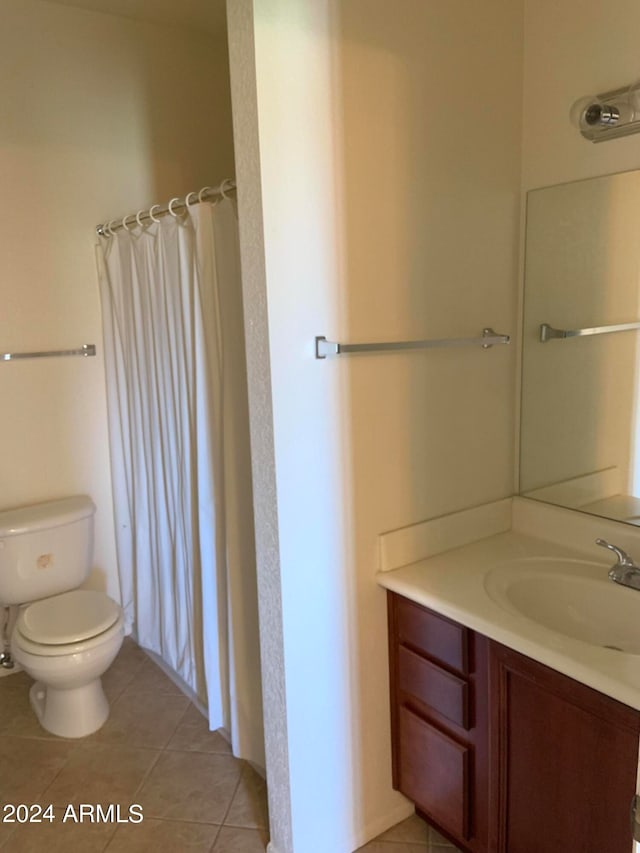 bathroom with tile patterned flooring, vanity, toilet, and a shower with curtain