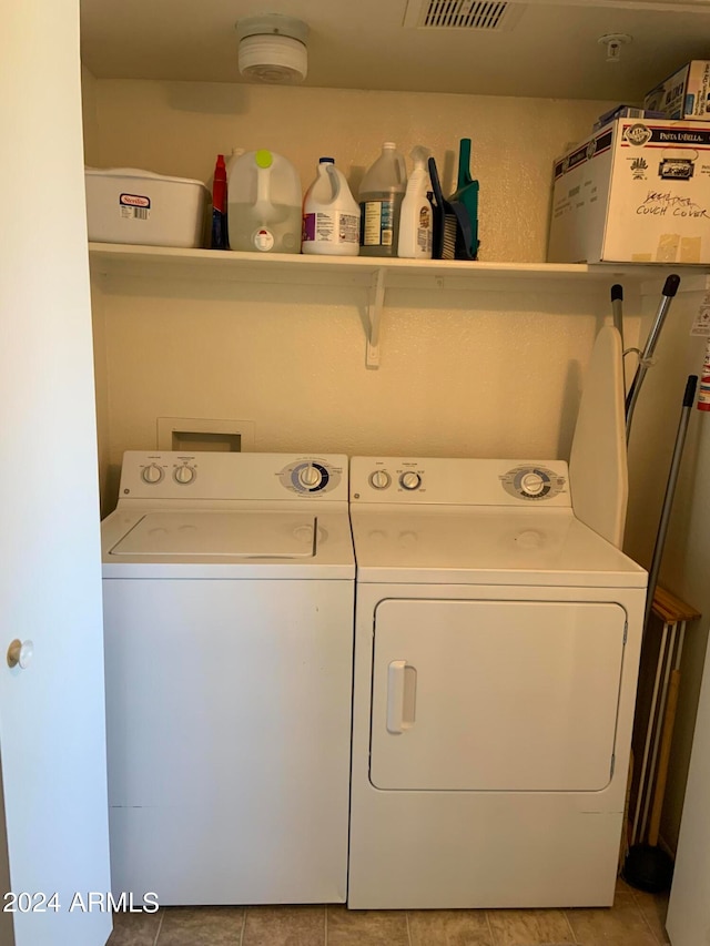 washroom with washer and dryer and light tile patterned flooring