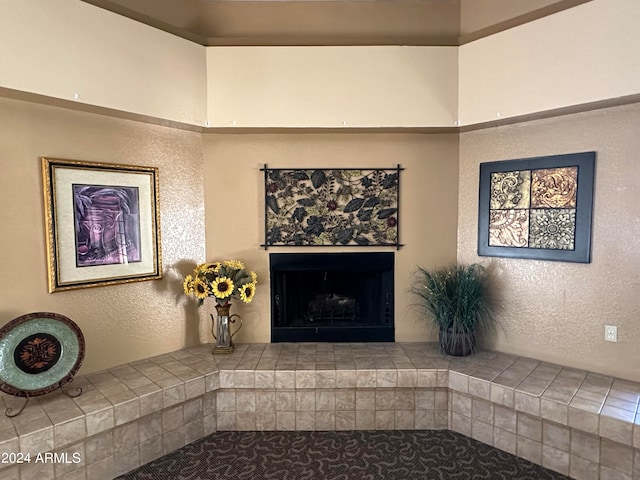 unfurnished living room featuring a tiled fireplace